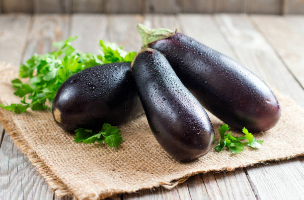 Fresh eggplant on wooden background Fresh eggplant on wooden background eggplant stock pictures, royalty-free photos & images