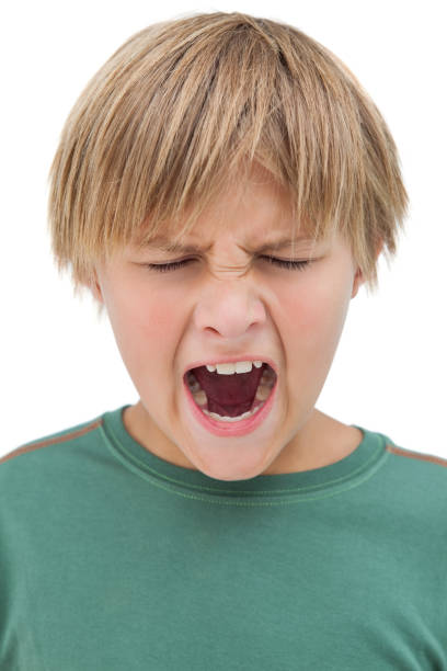 istock Furious little boy shouting with eyes closed 827772864