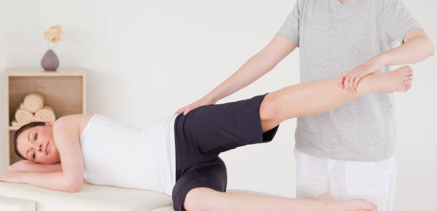 istock Sportswoman having a leg and hips stretching 827775924