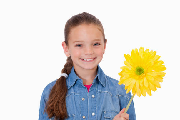 istock Girl holding a yellow flower 827776940