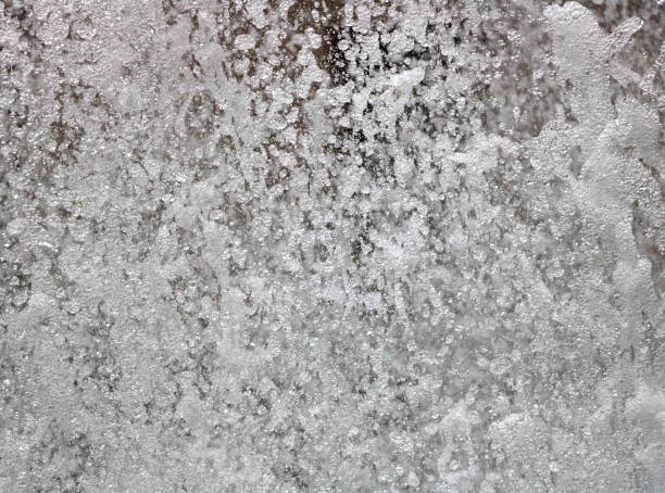 istock Closeup of falling water from fountain 827780294