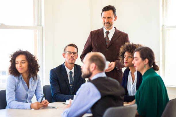 istock Office Workers in Meeting Looking at Something 827780424