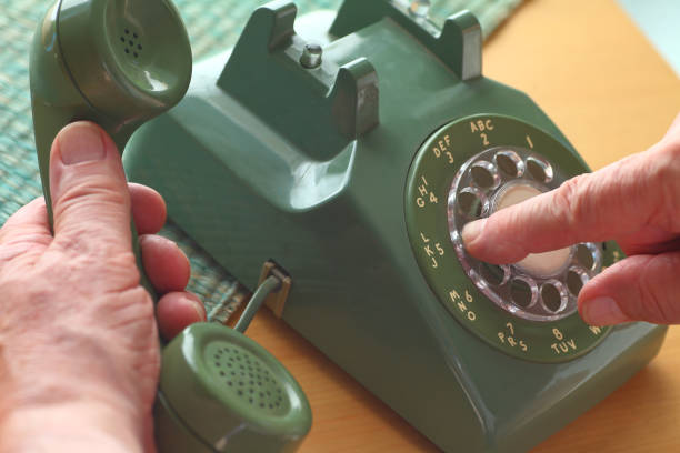 istock Man uses old rotary phone 827780930