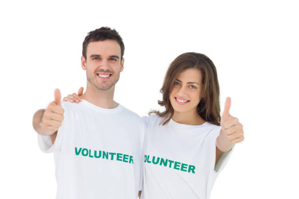 istock Two young volunteers giving thumbs up 827783520
