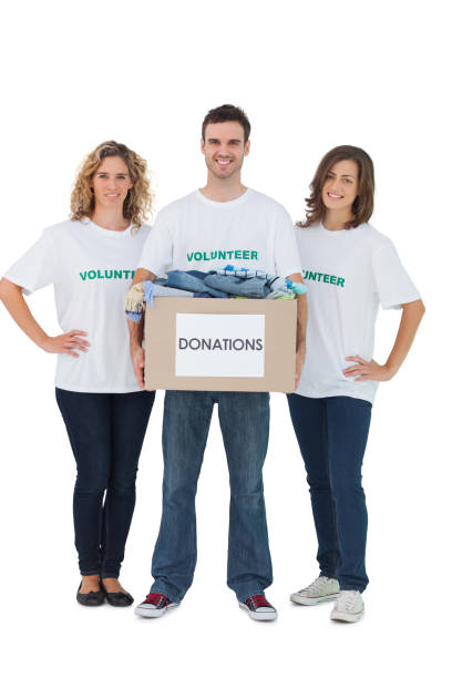 istock Group of volunteers holding donation box with clothes 827783552