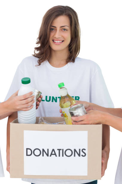istock Smiling volunteer holding a food donation box 827783622