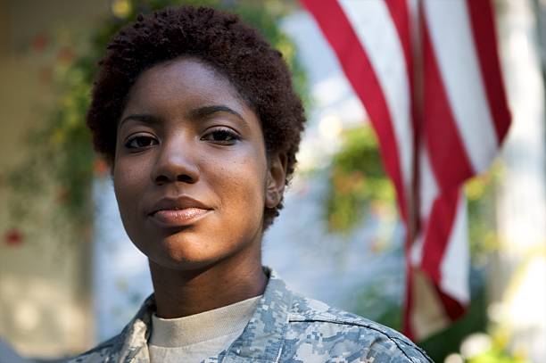 Portrait of Soldier in Uniform  Portrait of a African American Soldier in Uniform with flag in background. us military stock pictures, royalty-free photos & images