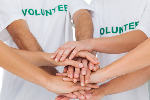 istock Volunteers piling up their hands together 827783668
