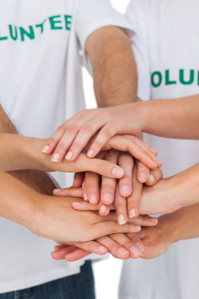 istock Volunteers putting hands together 827783678