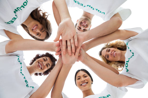 istock Cheerful group of volunteers putting hands together 827783752