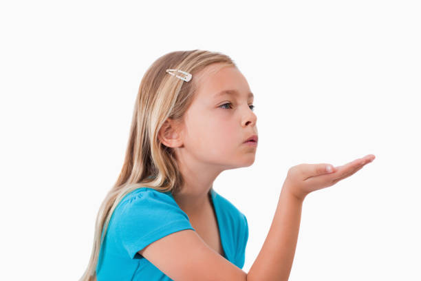 istock Girl blowing a kiss 827788542