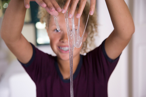 A Young Girl Plays with home made free-flowing play gel.