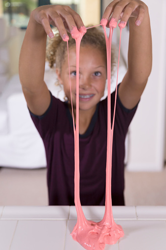 A Young Girl Plays with home made free-flowing play gel