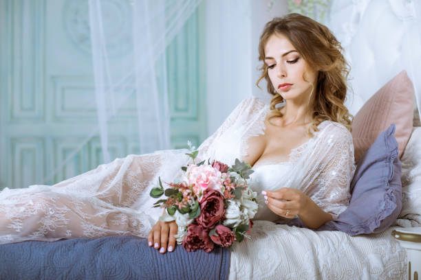 istock Beautiful sexy lady in elegant white robe 827789084