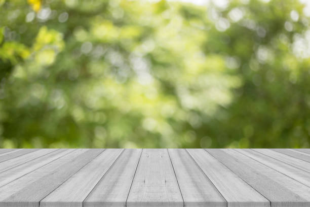istock black and white table top on green blurred background,Space for placing goods 827789216