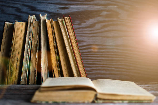 istock A stack of old books on a wooden table 827792604