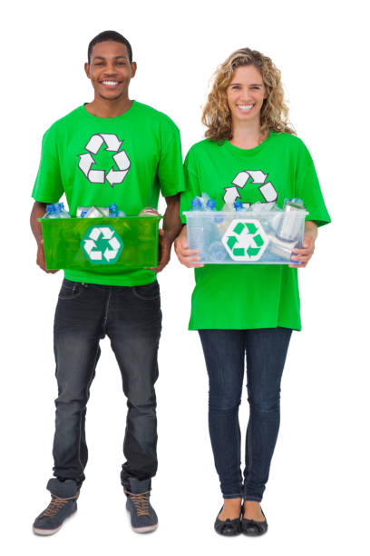 istock Two environmental activists carrying box of recyclables 827792852