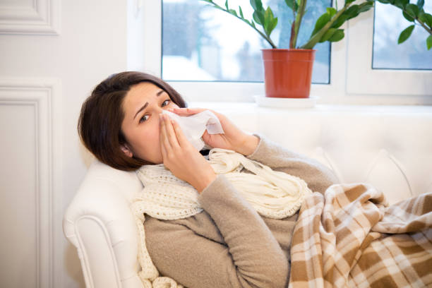 istock girl lying on the couch with a cold 827793170