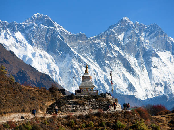 Stupa near Namche Bazar and Mount Everest,  Lhotse south rock face Stupa near Namche Bazar and Mount Everest, Lhotse south rock face - way to Everest base camp - Nepal base camp photos stock pictures, royalty-free photos & images