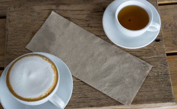 istock White glass Hot cappuccino on wooden table 827798762