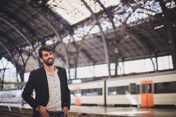 istock Man standing at railroad station 827799284