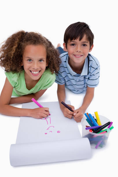 istock Portrait of smiling friends drawing while lying on the floor 827799578