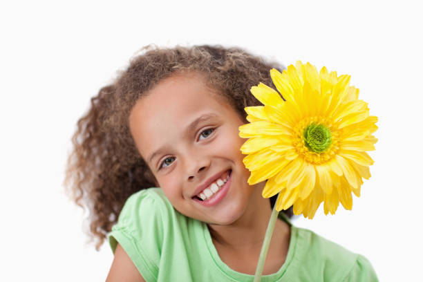 istock Little girl holding a flower 827799590