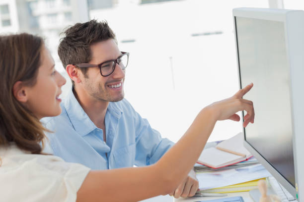 istock Attractive photo editor pointing at the computer screen 827804058