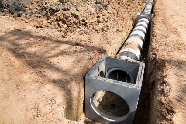 Concrete drainage pipe and manhole on construction site. Concrete drainage pipe and manhole on construction site. ditch stock pictures, royalty-free photos & images