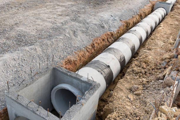 Concrete drainage pipe and manhole on construction site.