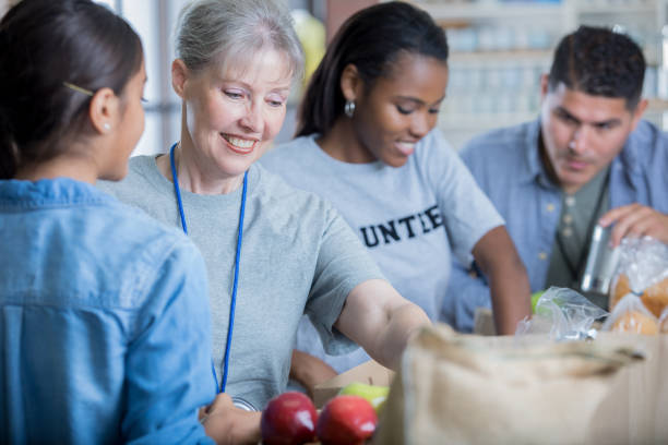 istock Cheerful volunteers organize items during food drive 827810188