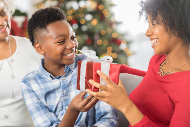 istock Happy single mom gives her son a Christmas gift 827810340