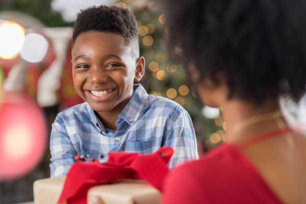 istock Excited elementary age boy gives his mom a Christmas gift 827810354