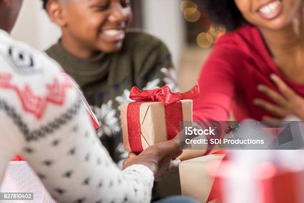 Man Gives Adult Daughter A Gift At Christmas Stock Photo - Download Image  Now - Gift, Christmas Present, Giving - iStock