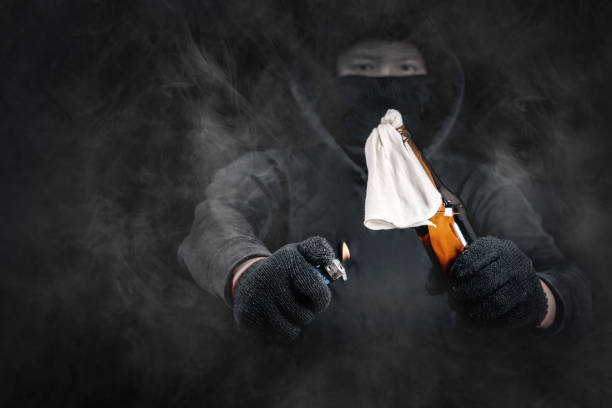 istock Protester or terrorist with Molotov cocktail (petrol bomb) with smoke dramatic screen 827814706