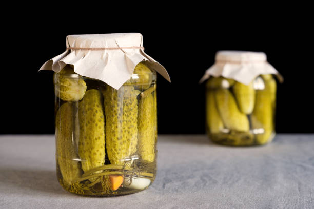 istock Two glass jars with pickled cucumbers 827817288