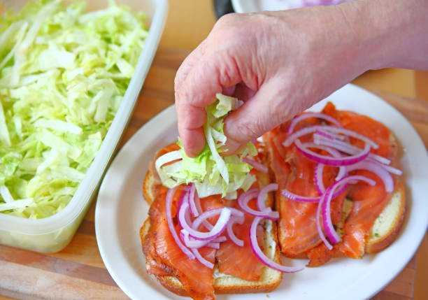 istock Adding lettuce to smoked salmon sandwich 827818326