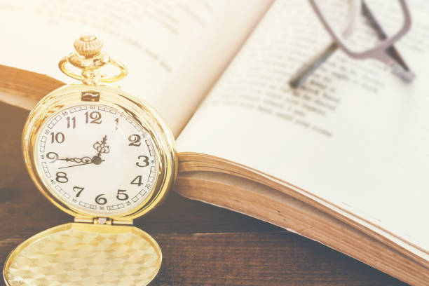 istock Pocket Watch on age book background 827818640