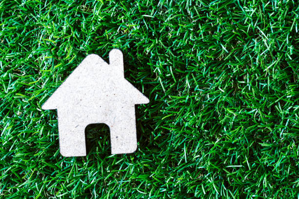 istock Small model house on green grass background 827821252