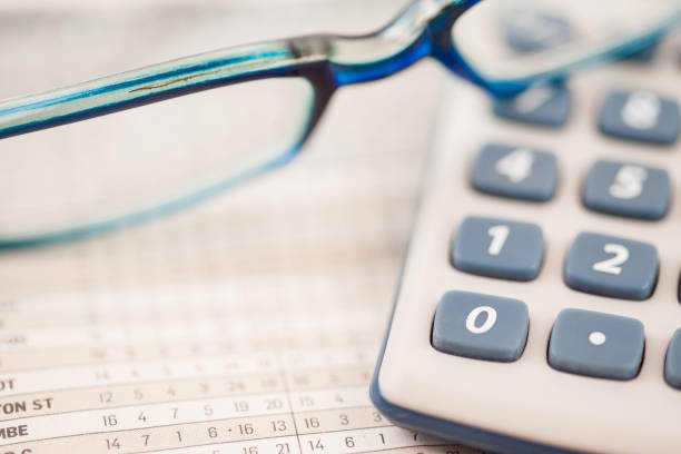 istock Close up of glasses and calculator 827826080