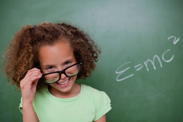 istock Smart schoolgirl looking above her glasses 827826274