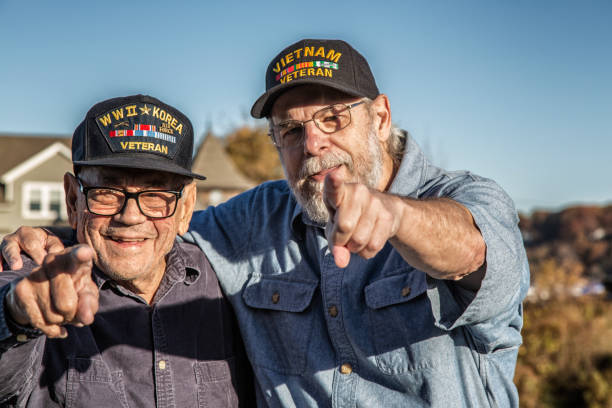 istock Two Generations USA Military War Veterans Pointing Playfully at Camera 827830166