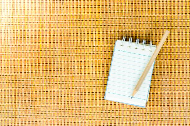 istock Notepad with pencil on wood board background. using wallpaper or background for education, business photo. Take note of the product for book with paper and concept, copy space. 827834186