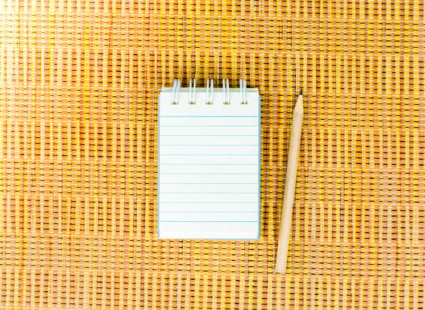 istock Notepad with pencil on wood board background. using wallpaper or background for education, business photo. Take note of the product for book with paper and concept, copy space. 827834196