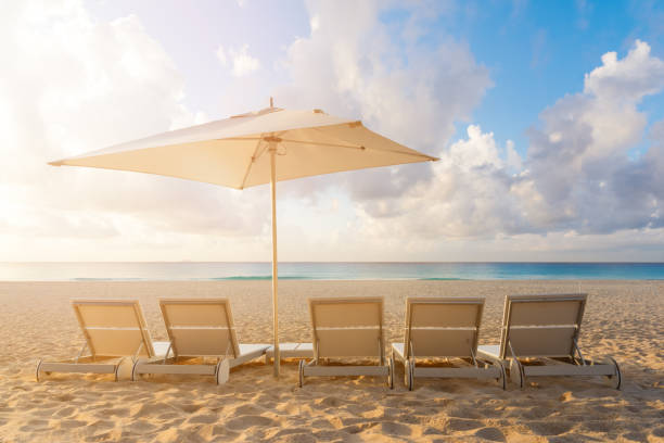 istock Five Beach chairs and Umbrella on the white sand beach with cloudy blue sky and sun 827834502
