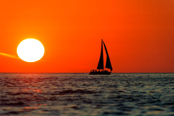 istock Ocean Sunset Sailboat Sailing Silhouette 827834598