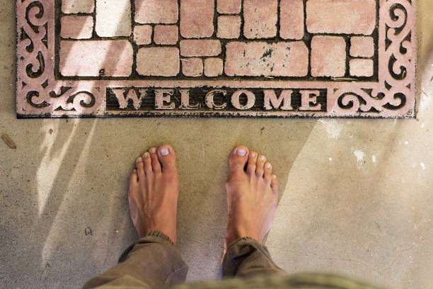 Point Of View Bare Feet At Home Welcome Door Mat stock photo