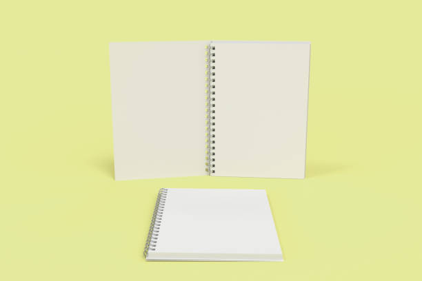 istock Two notebooks with spiral bound on yellow background 827836972
