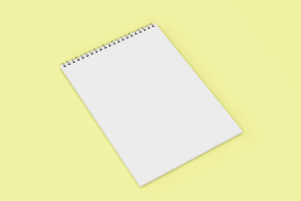 istock Blank white notebook with metal spiral bound on yellow background 827837028
