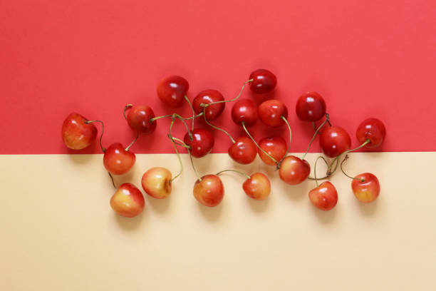 istock Ripe red and yellow cherry on a colored background 827837054